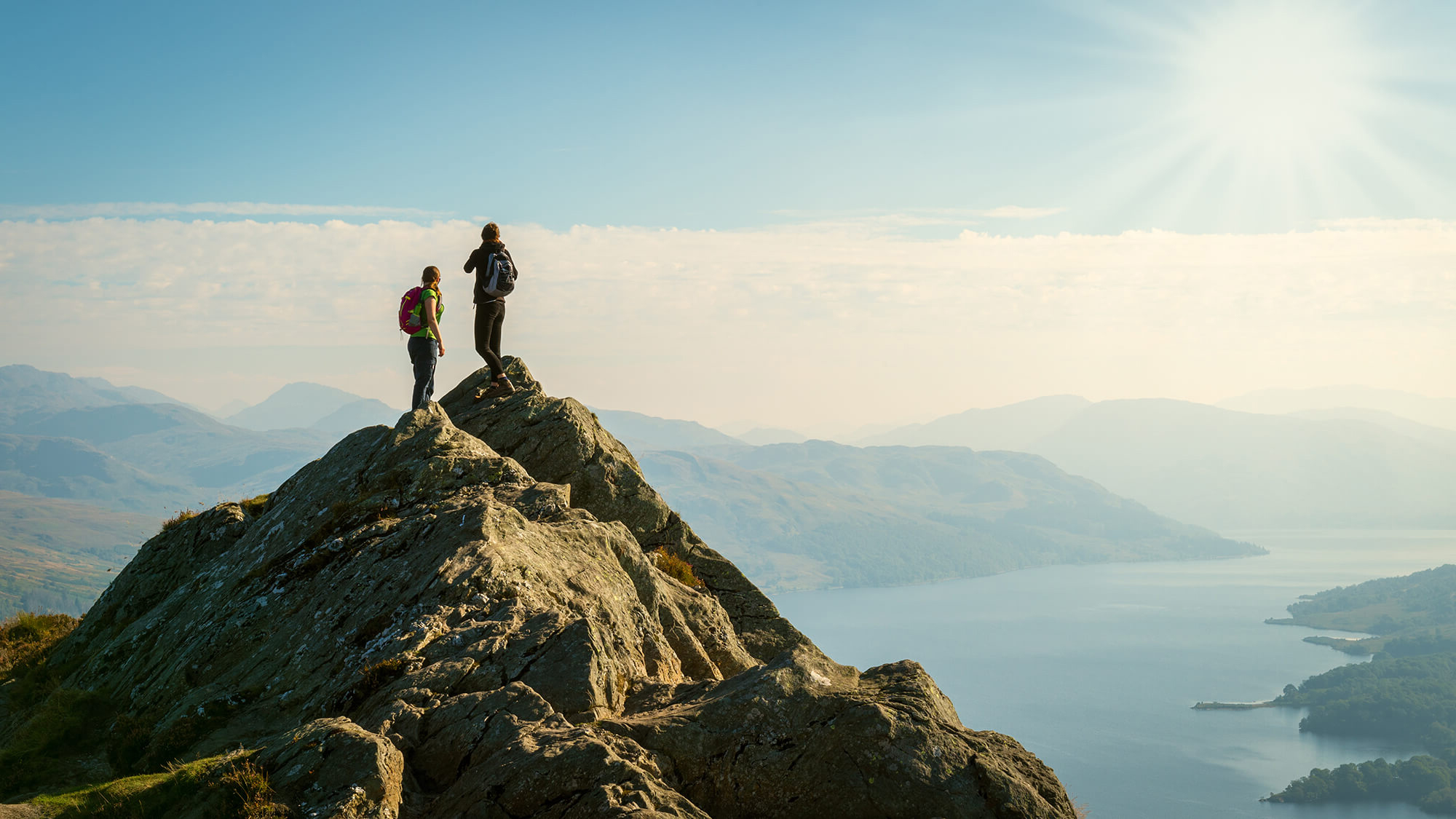 Two men standing on top of mountain